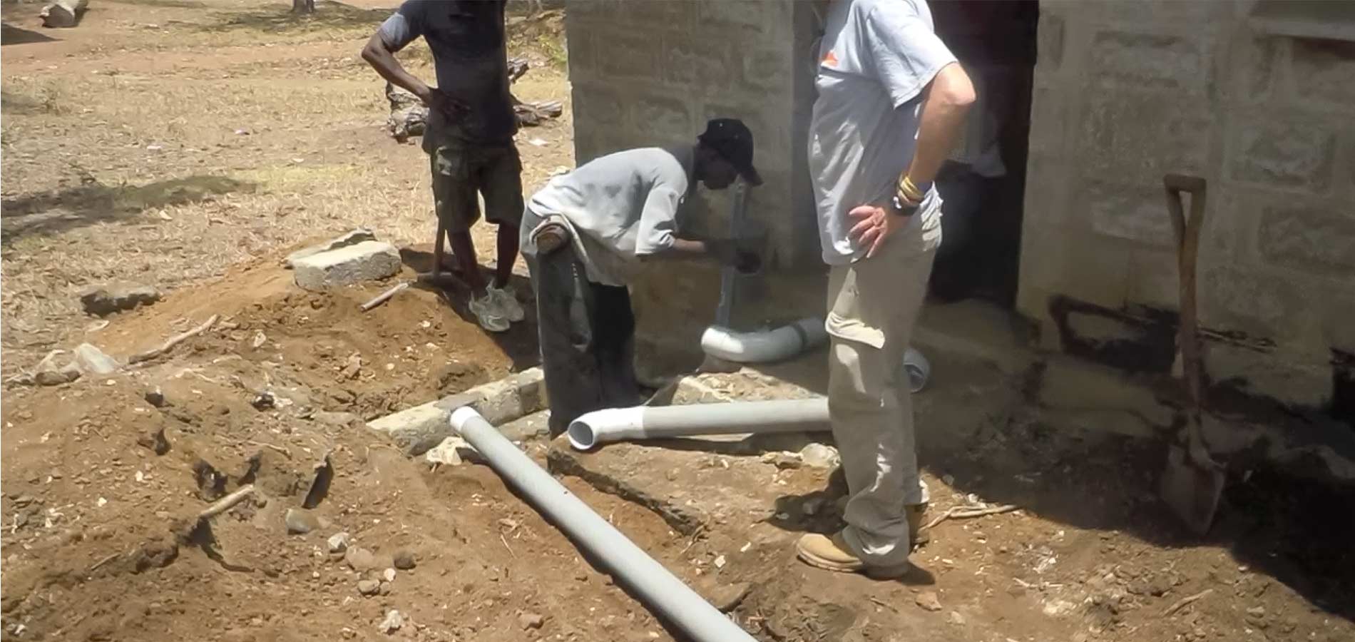 Our first task was to improve the sanitation in the boy's and girl's bathrooms. Here the piping goes in.